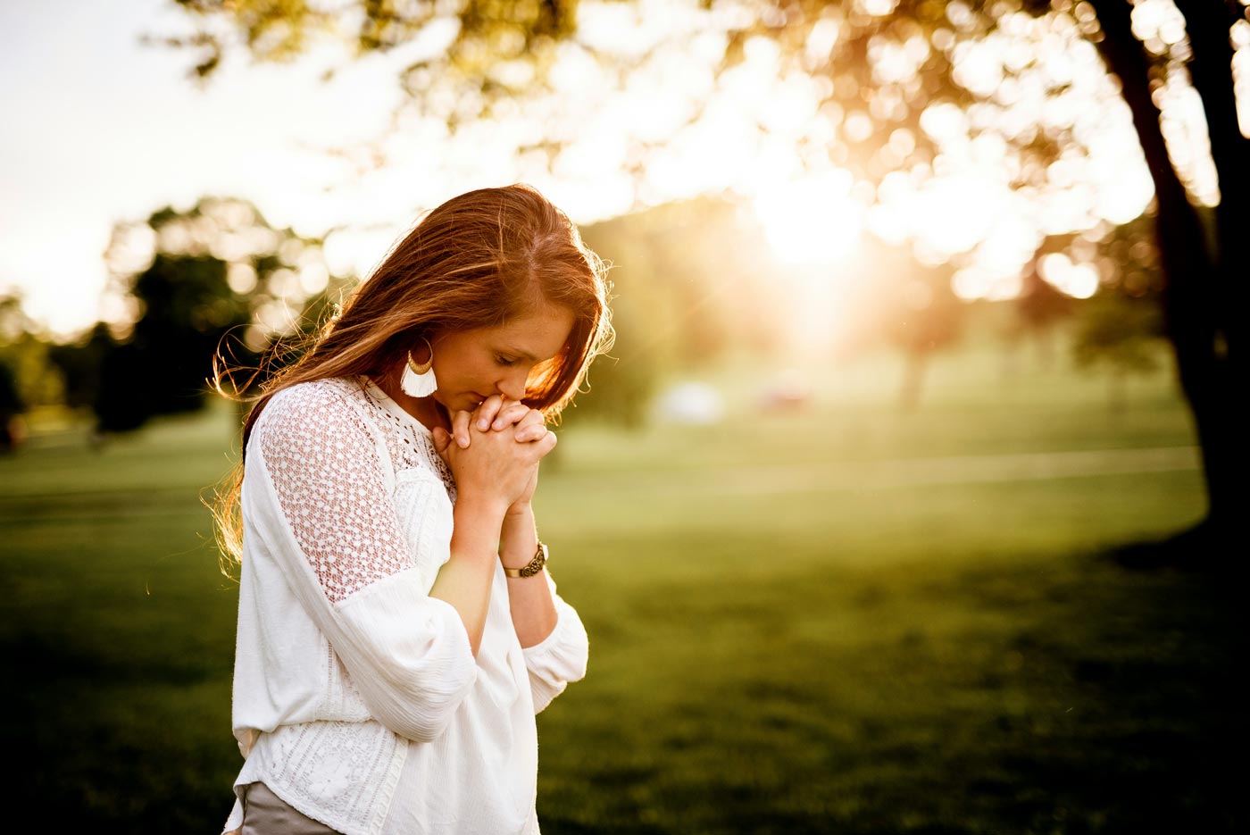 Calming Transformations Counseling - a woman praying at sunset - Therapy for Latter-Day Saints