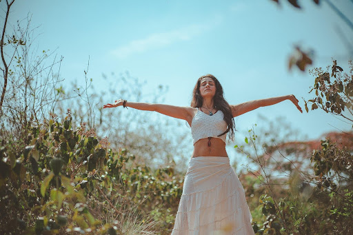 Woman with open arms in nature