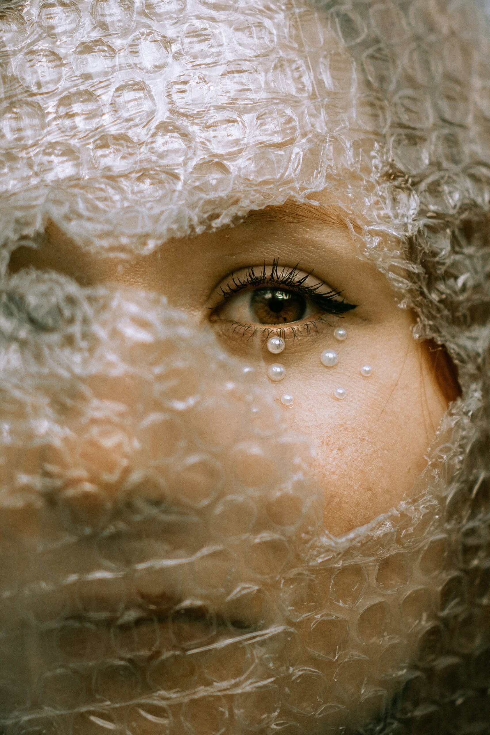 woman looking through bubble wrap