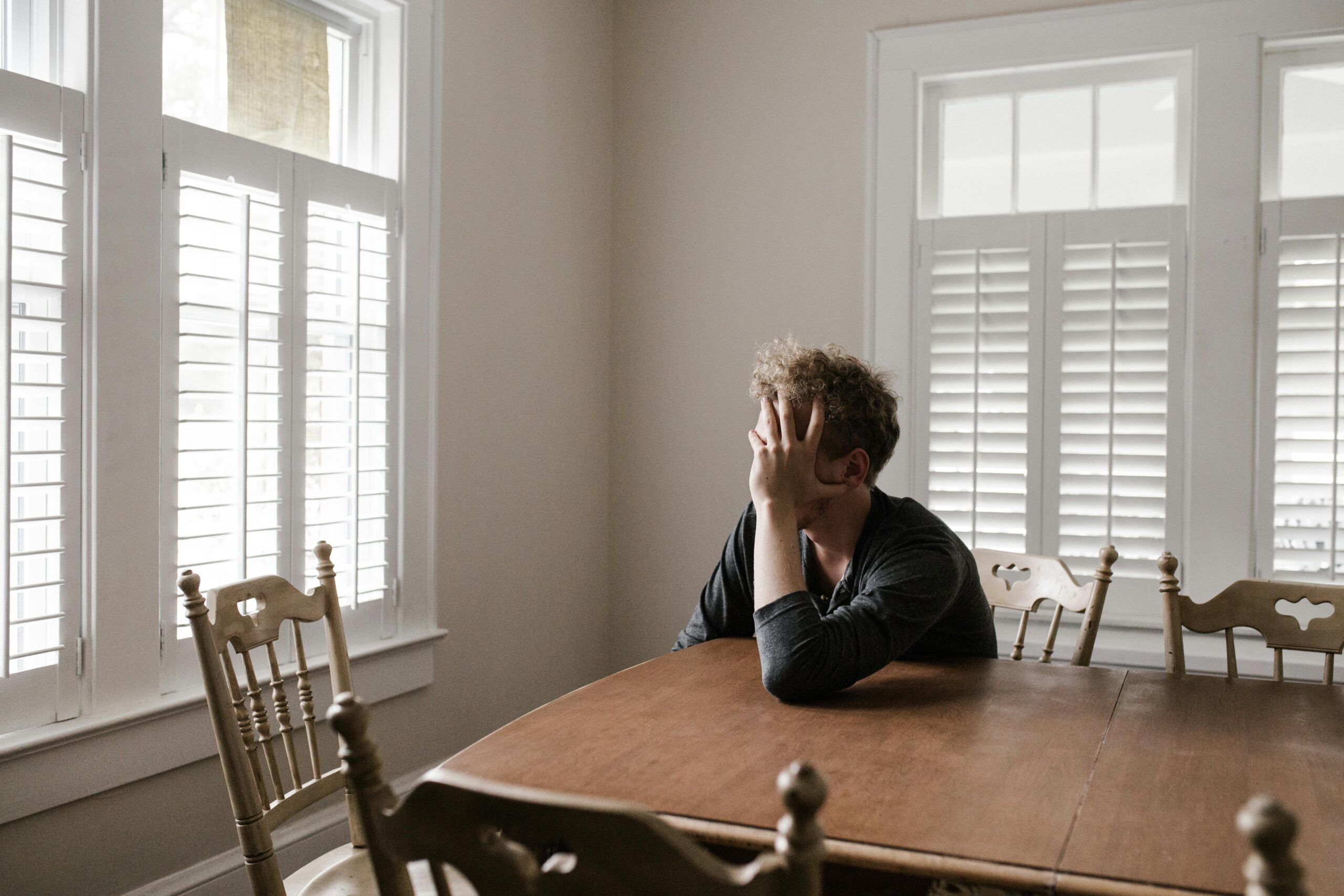 Man looking out window